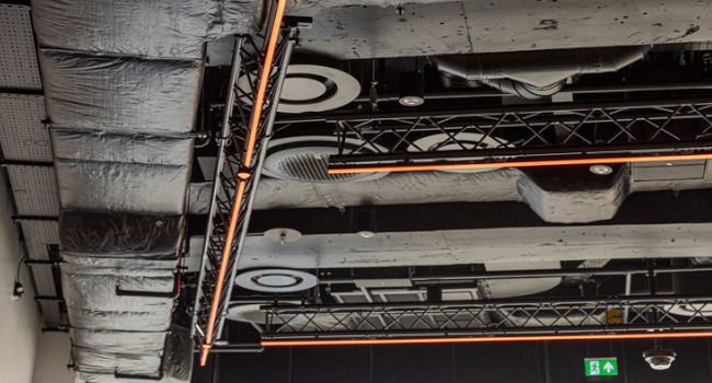 Services raised to fit between existing dropped beams.